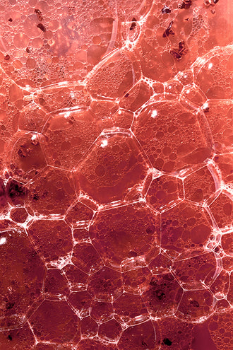 Closeup of red liquid with bubbles